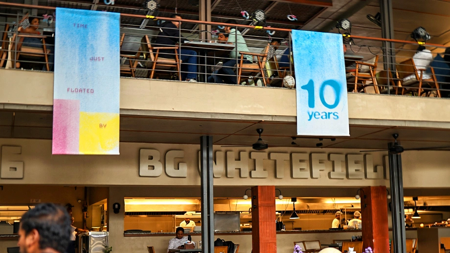 Biergarten displaying 10-year anniversary celebration banners across its multi-level microbrewery in Bangalore.