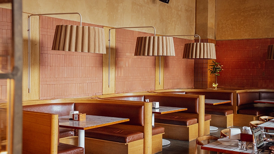 Booth seating with brick accent walls at Biergarten, one of the best restaurants in Manyata Tech Park.